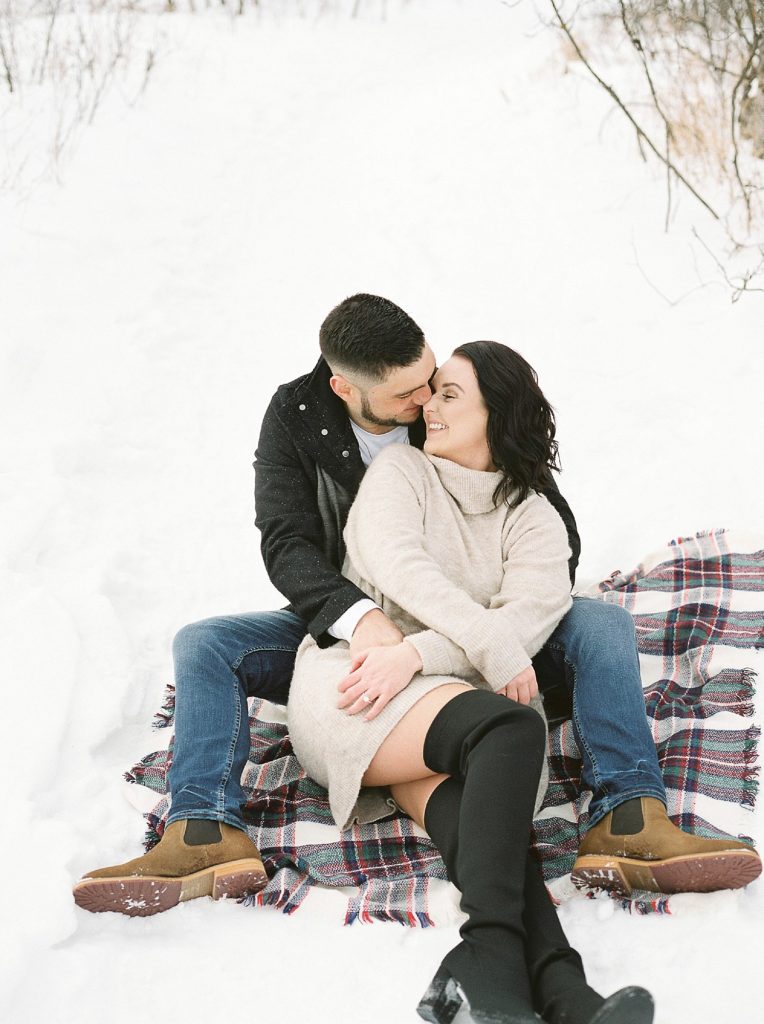 romantic winter engagement session with bride-to-be & fiance in cozy cold weather attire