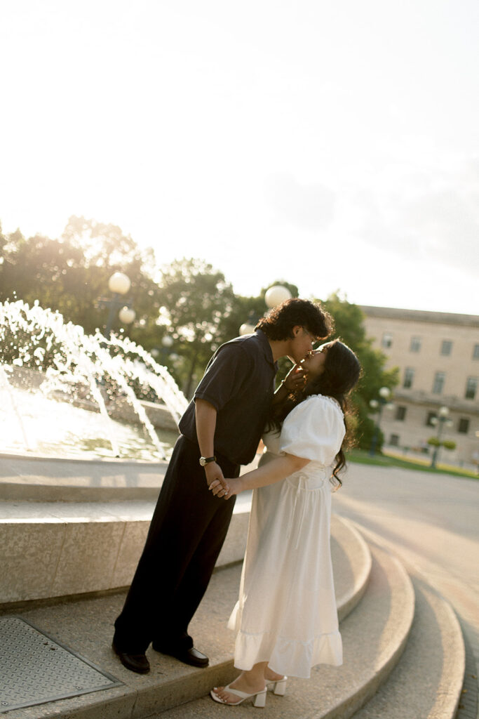romantic engagement session with bride-to-be in white dress and fiancé in black at manitoba legative building