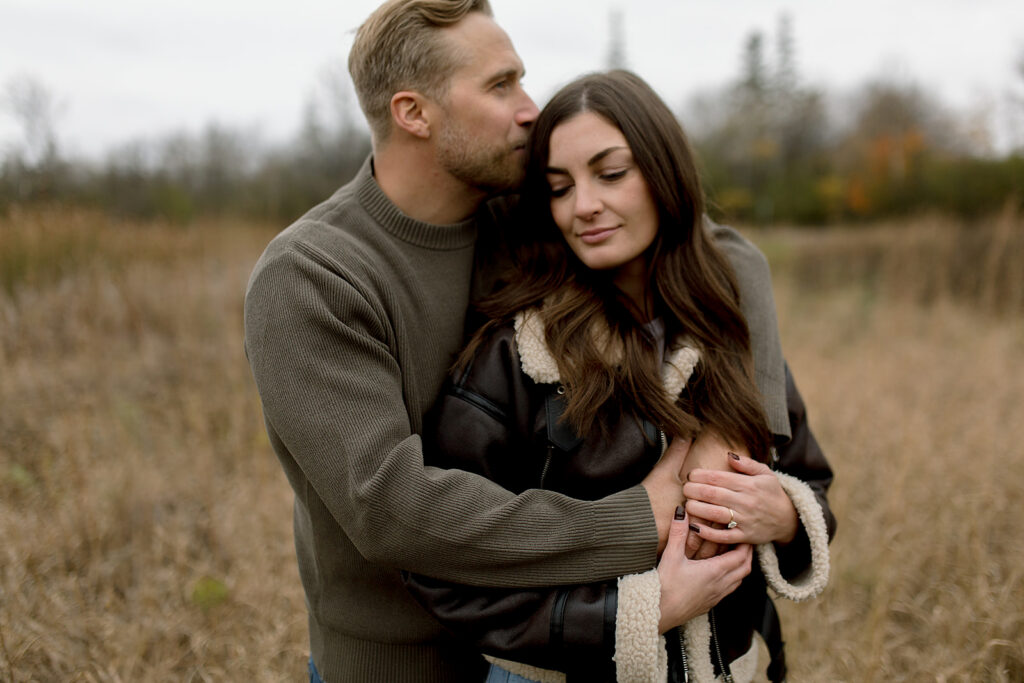 romantic winnipeg engagement session of couple in fall weather attire at assiniboine park