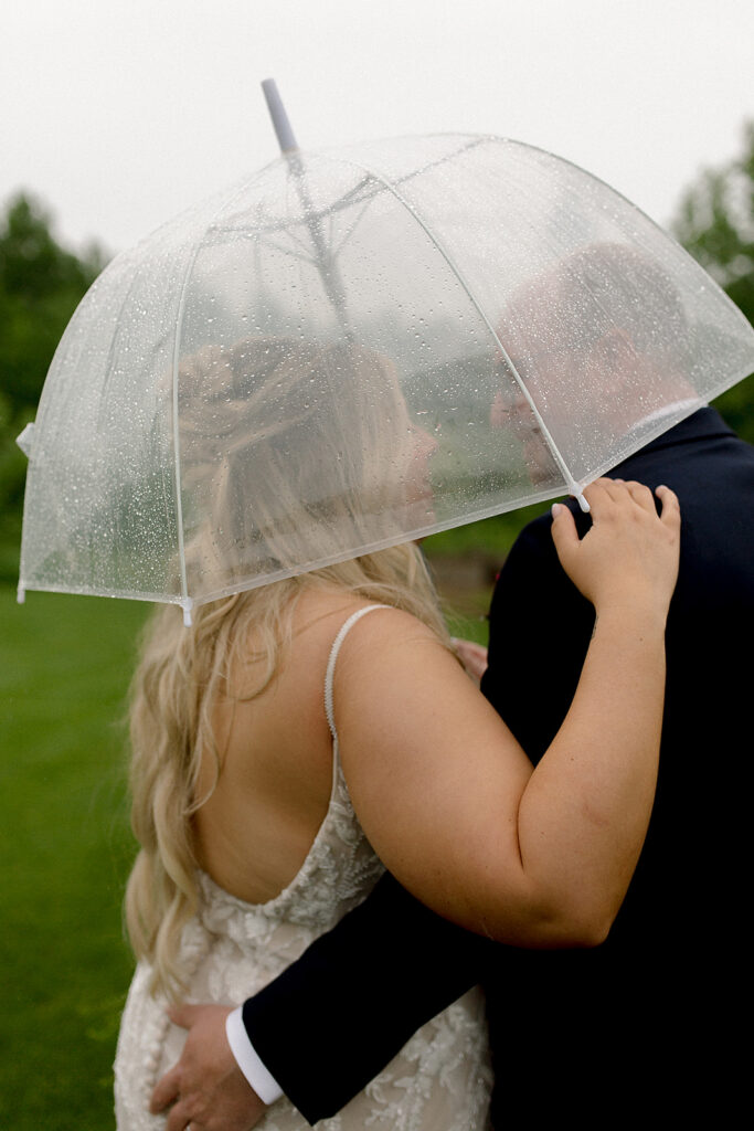 the white poplar wedding venue couple rainy day umbrella photos